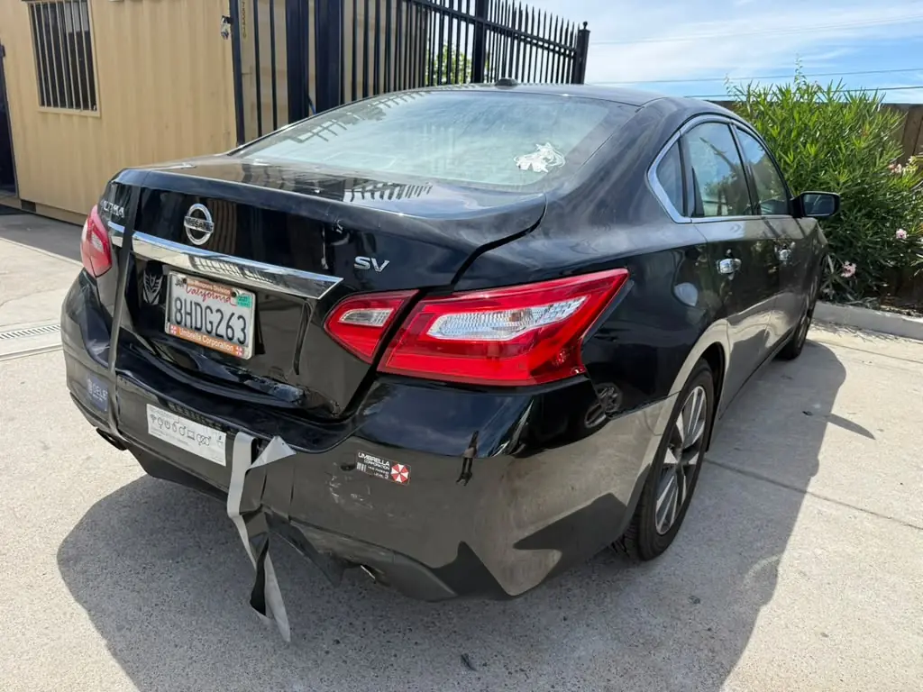 Nissan Altima rear corner with a hanging bumper, before repair