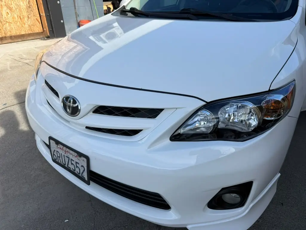 White Toyota Corolla front end after repair