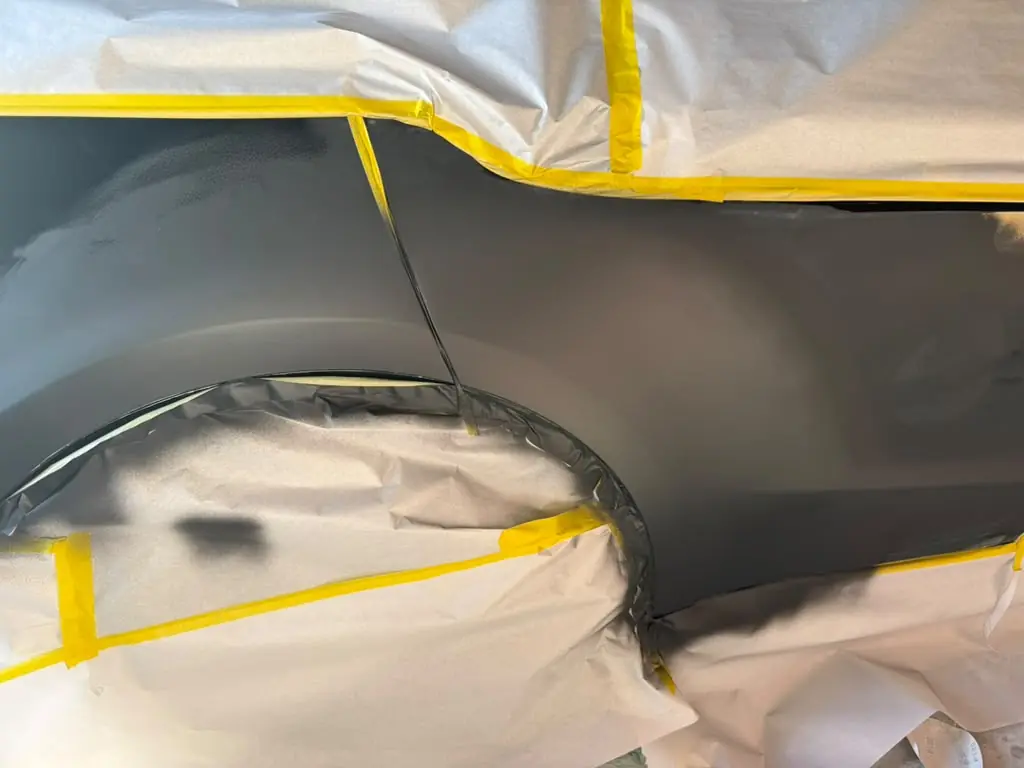Tesla rear quarter panel masked off for paint